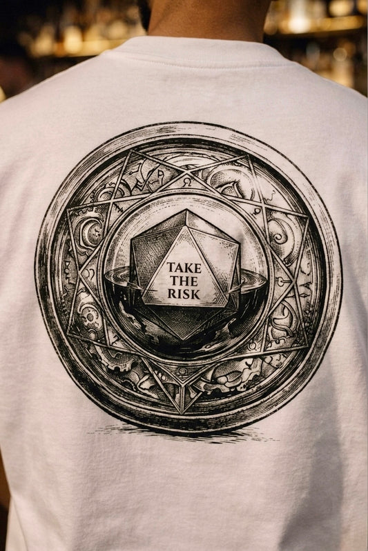 White t-shirt with a black circular design on the back featuring text 'Take the Risk'.