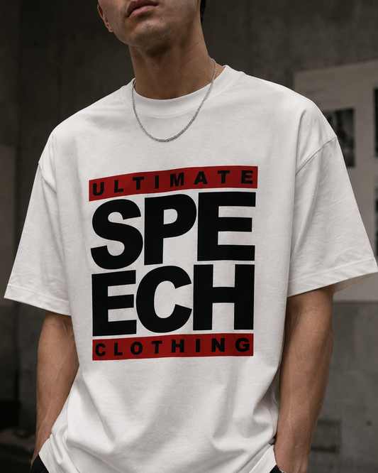 A man wearing a white graphic t-shirt with bold black text reading 'SPEECH' and red banners reading 'ULTIMATE' and 'CLOTHING' on the front.
