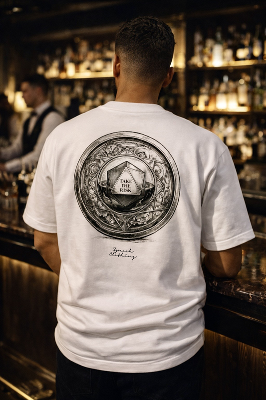 Person wearing a white t-shirt with a black graphic design in a bar setting