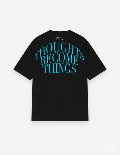 Black t-shirt with blue text 'THOUGHTS BECOME THINGS' on a white background