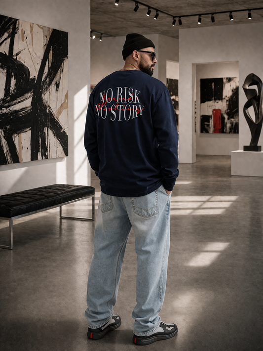 Person wearing a sweatshirt with 'No Risk No Story' text in an art gallery.