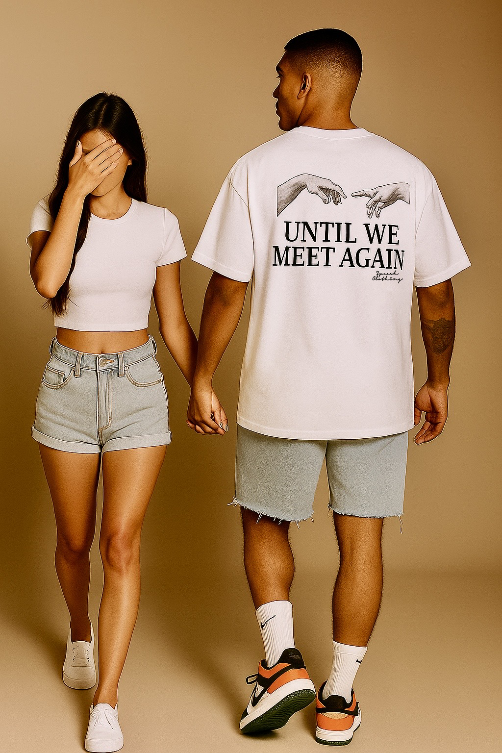 Two people walking hand in hand on a beige background, with one person wearing a shirt with text on the back.