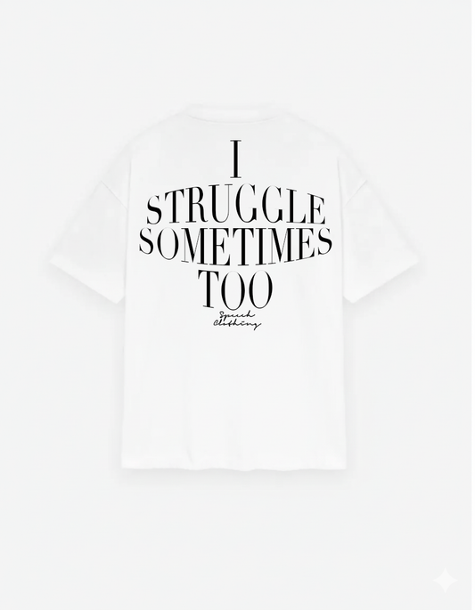 White t-shirt with black text 'I STRUGGLE SOMETIMES TOO' on a white background